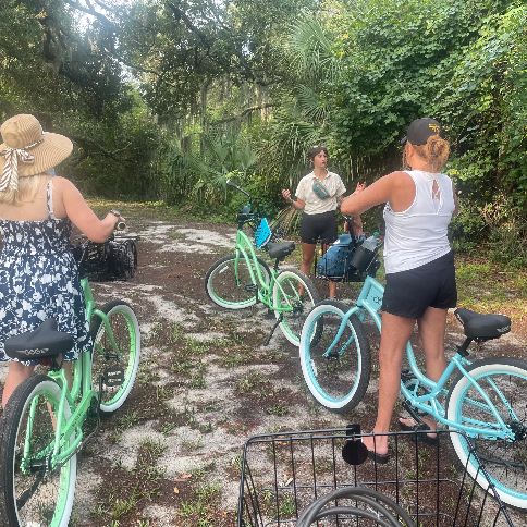 Riders on a shaded sandy trail on Tybee Island during one of our guided bike tours